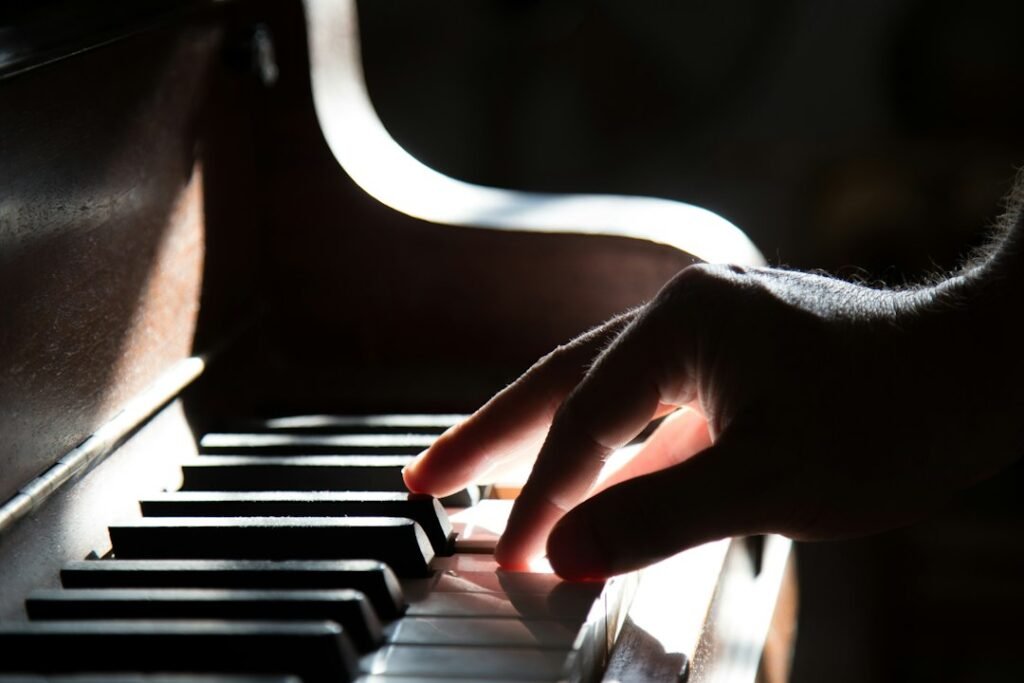 Hands playing piano keys during beginner practice