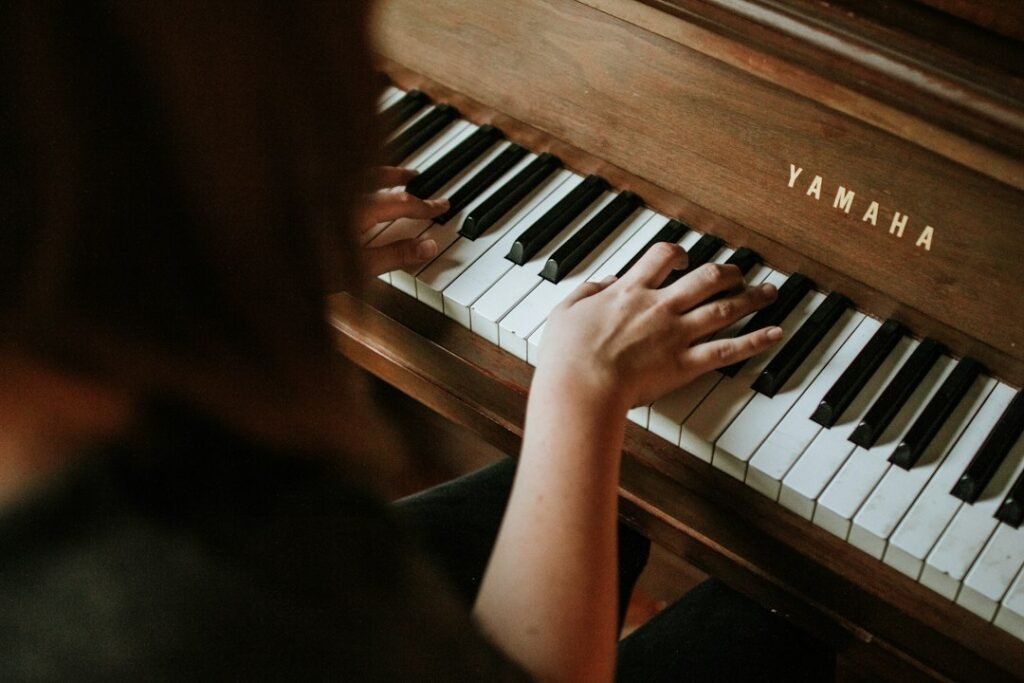 Adult hands practicing at a piano keyboard